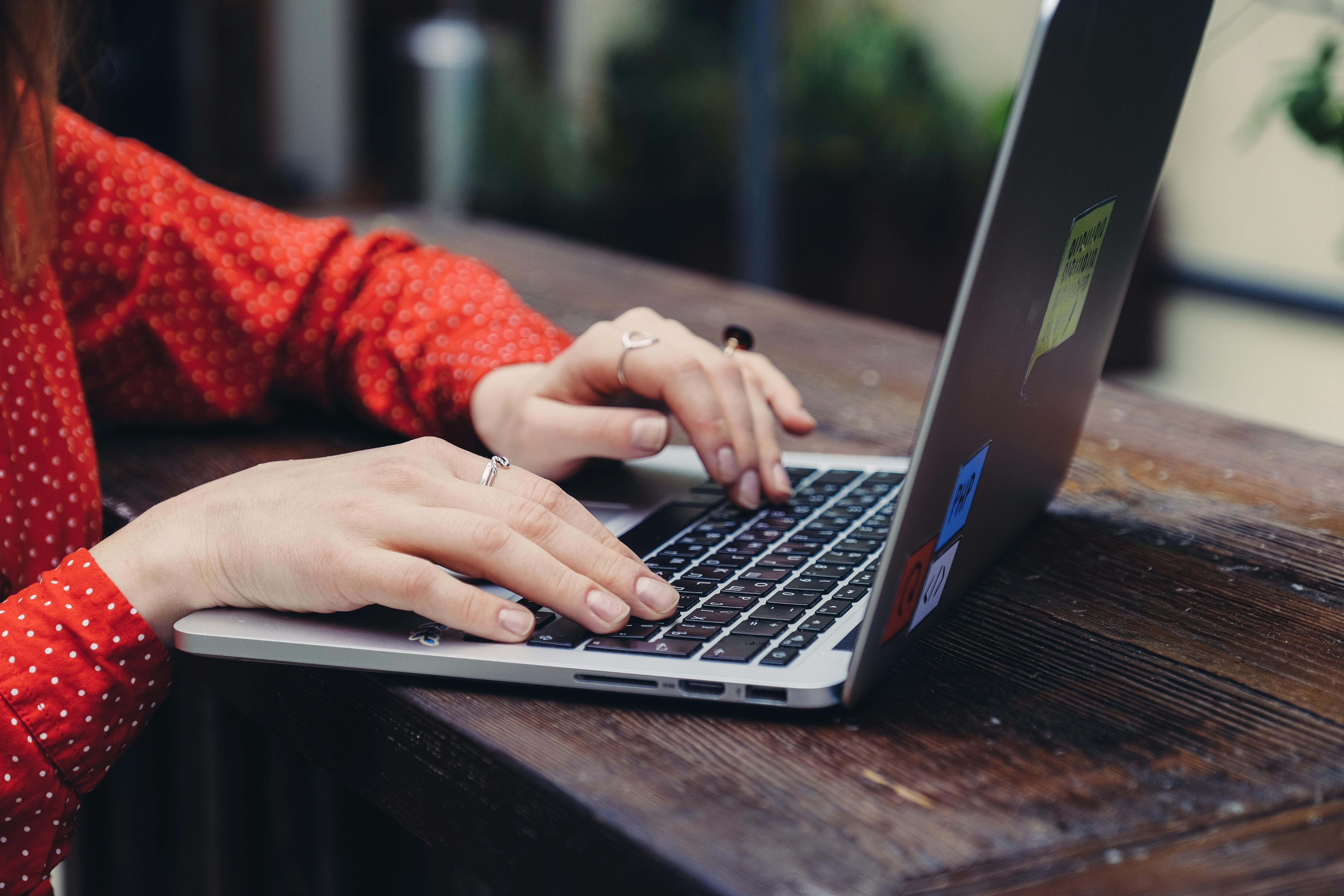 A laptop on a wooden table representing IT studies